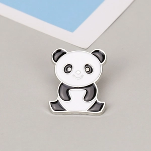 Close-up of cute cartoon panda enamel brooch with black and white finish on metal base