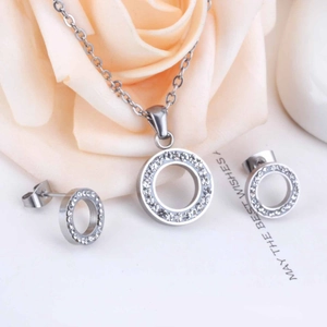 Detailed view of silver stainless steel jewelry set with sparkling pavé crystal circles