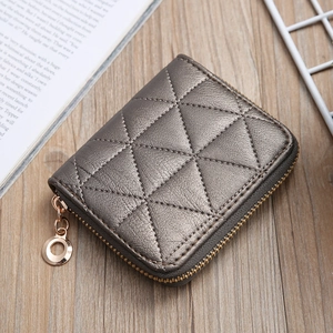 Top view of a gun-grey PU leather card holder with quilted stitching and gold zipper