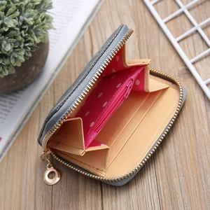 Short grey PU leather zip wallet for women with pink polka dot lining and card slots