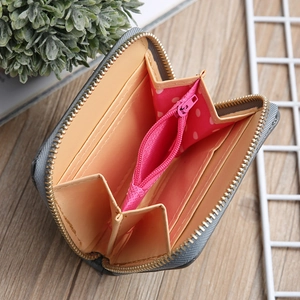 Mini grey stitched coin purse with pink polka dot pocket and secure gold zipper