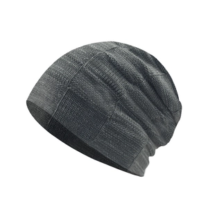 Detailed view of dark grey knitted beanie with thick checkered weave texture