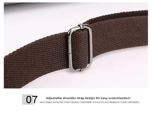 Detail of dark brown canvas strap with adjustable silver metal buckle on a shoulder bag