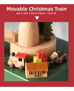 Close-up of a wooden Christmas music box with moving train and festive decorations