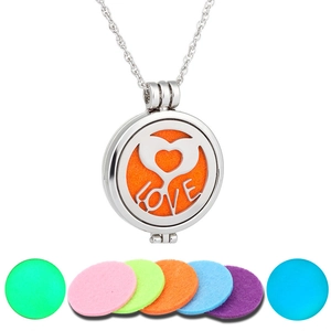 Detail of hollow heart and LOVE locket with colorful felt pads for essential oils
