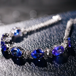 Macro detail of silver bracelet with oval blue tanzanite and sparkling diamond accents