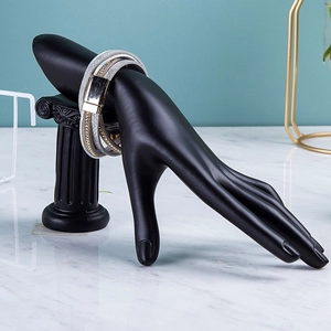 Detailed view of multi-layer wrap bracelet with magnetic clasp on black hand display stand