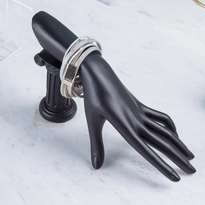 Bohemian multilayer leather wrap bracelet with rhinestones on hand display stand