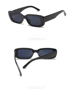 Detail view of stylish black rectangular sunglasses with vintage narrow frame and glossy finish
