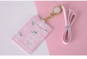 Detail of pink floral PU leather card holder with retractable lanyard and metal buckle