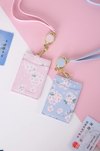 Detail of pink and blue PU leather ID card holders with retractable floral lanyard