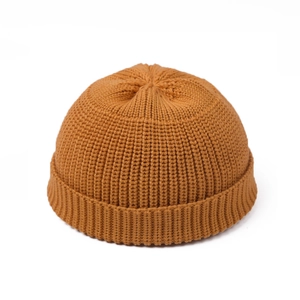 Detail of ginger yellow ribbed knit beanie showing thick texture and folded cuff