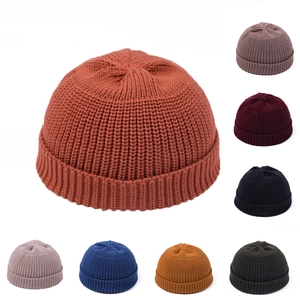 Detail of ribbed texture on docker hats showing various colors like brick red and black