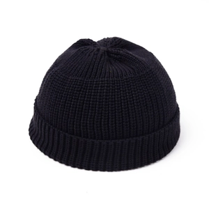 Close-up of the ribbed knit texture and folded cuff of this solid black beanie cap