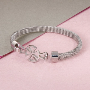 Silver stainless steel mesh chain bracelet with a unique cross-shaped clasp on a bicolor backdrop