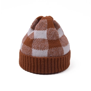 Close-up of brown and beige checkerboard knit beanie with ribbed cuff and soft texture