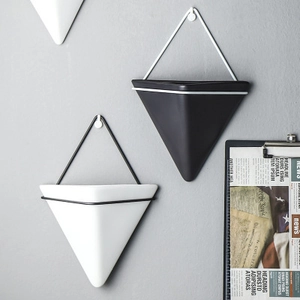 Minimalist geometric wall-mounted planter set in black and white Nordic style