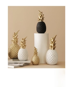 Macro detail of Nordic gold pineapple ornaments showing realistic texture and finish