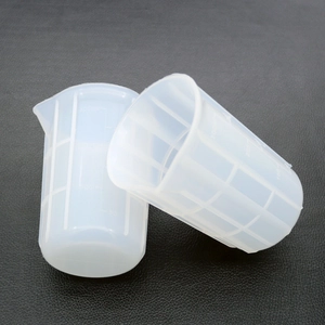 Detail of 100ml and 50ml silicone measuring cups with clear scale and pour spout