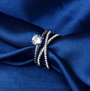 Sparkling double layer silver engagement ring set with round zircon on dark blue silk fabric