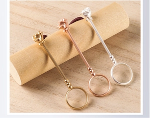 Detailed close-up of rose flower cigarette holder rings in gold, rose gold, and silver finishes