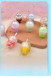 Close-up of assorted miniature smoothie cup keychains in vibrant colors on a wooden tray