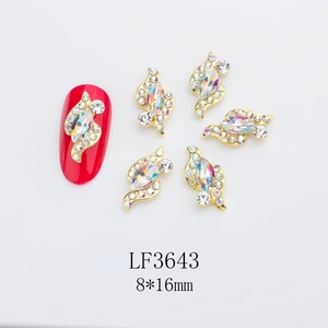 Macro view of gold 8x16mm horse-eye rhinestone nail charms with sparkling crystals