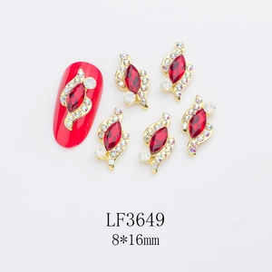 Detailed view of red marquise nail art rhinestones in gold setting with size 8x16mm