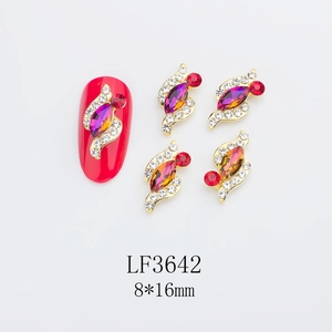 Close-up of 8x16mm horse-eye alloy nail charms with purple rhinestones on red nails