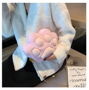 Close-up of pink plush cat paw bag with soft texture and gold chain shoulder strap