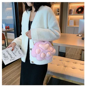 Detail of pink plush cat paw bag featuring 3D toe pads and premium gold chain strap