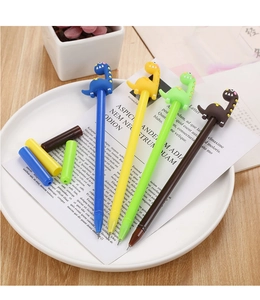 Detail of four dinosaur-shaped gel pens in blue, yellow, green and brown on a white plate