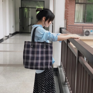Classic dark plaid canvas tote bag with black leather handles for school or work