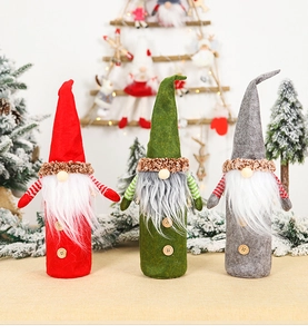 Detailed view of three felt Christmas gnome wine bottle covers in red, green and grey