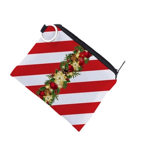 Close-up of a Christmas coin purse with red stripes, pine cones, and floral patterns