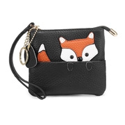 Detail of black lychee leather coin purse featuring a cute fox collage with wristlet strap