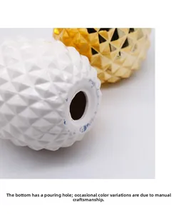 Macro view of ceramic pineapple decor base showing the firing hole and handmade texture