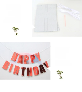 Macro shot of red metallic Happy Birthday letter banner set with white hanging ropes
