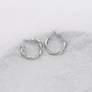 Silver twisted hoop earrings for women featuring a minimalist french design aesthetic
