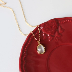 Retro 18K gold plated titanium necklace with velvet opal oval pendant on a red heart plate
