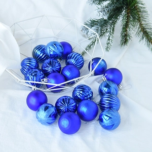 Royal blue Christmas ball ornaments with mixed textures in a white basket on snow fabric