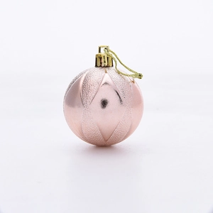 Close-up of pink 5cm Christmas ball featuring geometric matte textures and gold string