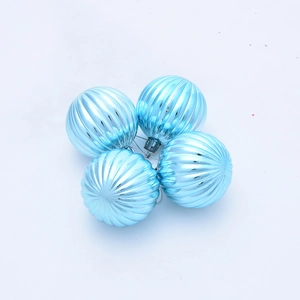 Close-up of four light blue pumpkin-patterned Christmas balls with silver string hangers