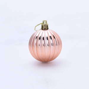 Detailed view of a 5cm pink ribbed Christmas ornament with a metallic finish and gold hook