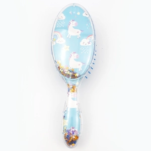 Detail of blue unicorn transparent hairbrush with colorful sequins and star patterns