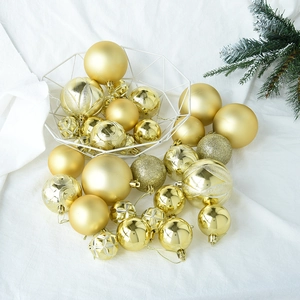 Detailed view of assorted gold Christmas ornaments with matte, glitter and embossed textures