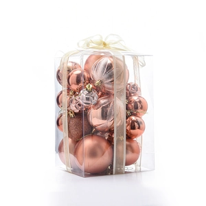 Detail of rose gold Christmas ball ornaments with glitter and matte finishes in a gift box