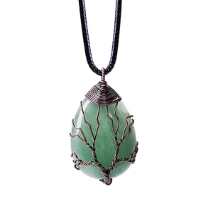 Close-up of teardrop green stone necklace with bronze tree of life wire wrapping