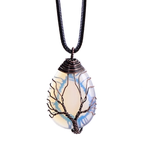 Macro detail of handmade wire-wrapped tree of life pendant with opal teardrop stone