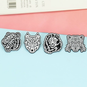 Set of four geometric animal enamel pins featuring tiger, wolf, lion and leopard designs